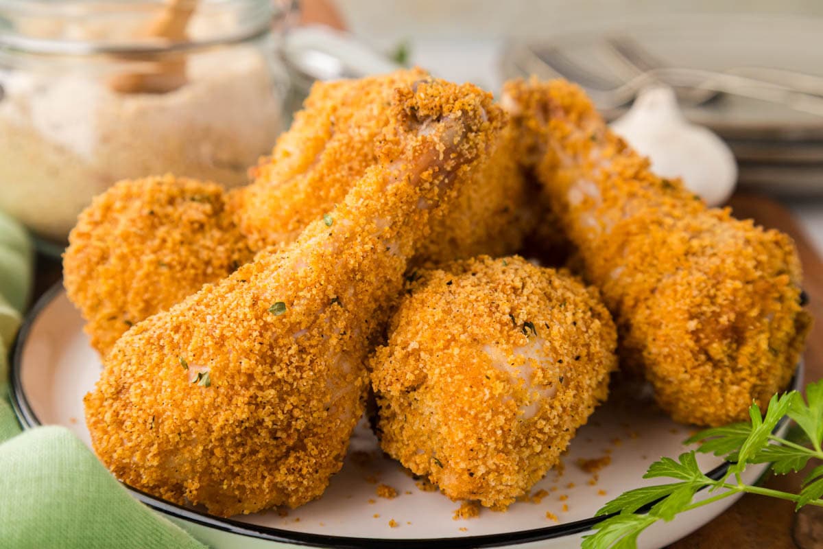 Cooked shake and baked chicken legs on a white plate.