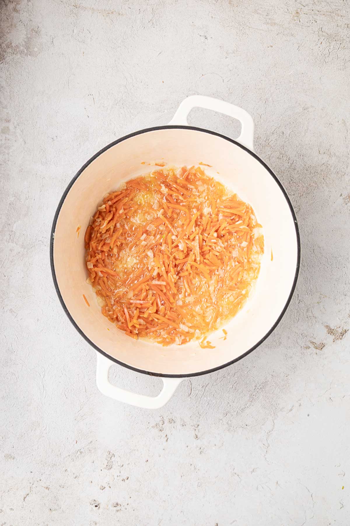 Garlic added to sautéed carrots and onions.