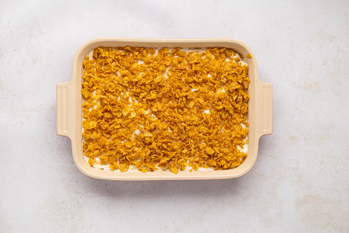 Crunchy corn flake mixture sprinkled on top of the chicken casserole mixture.