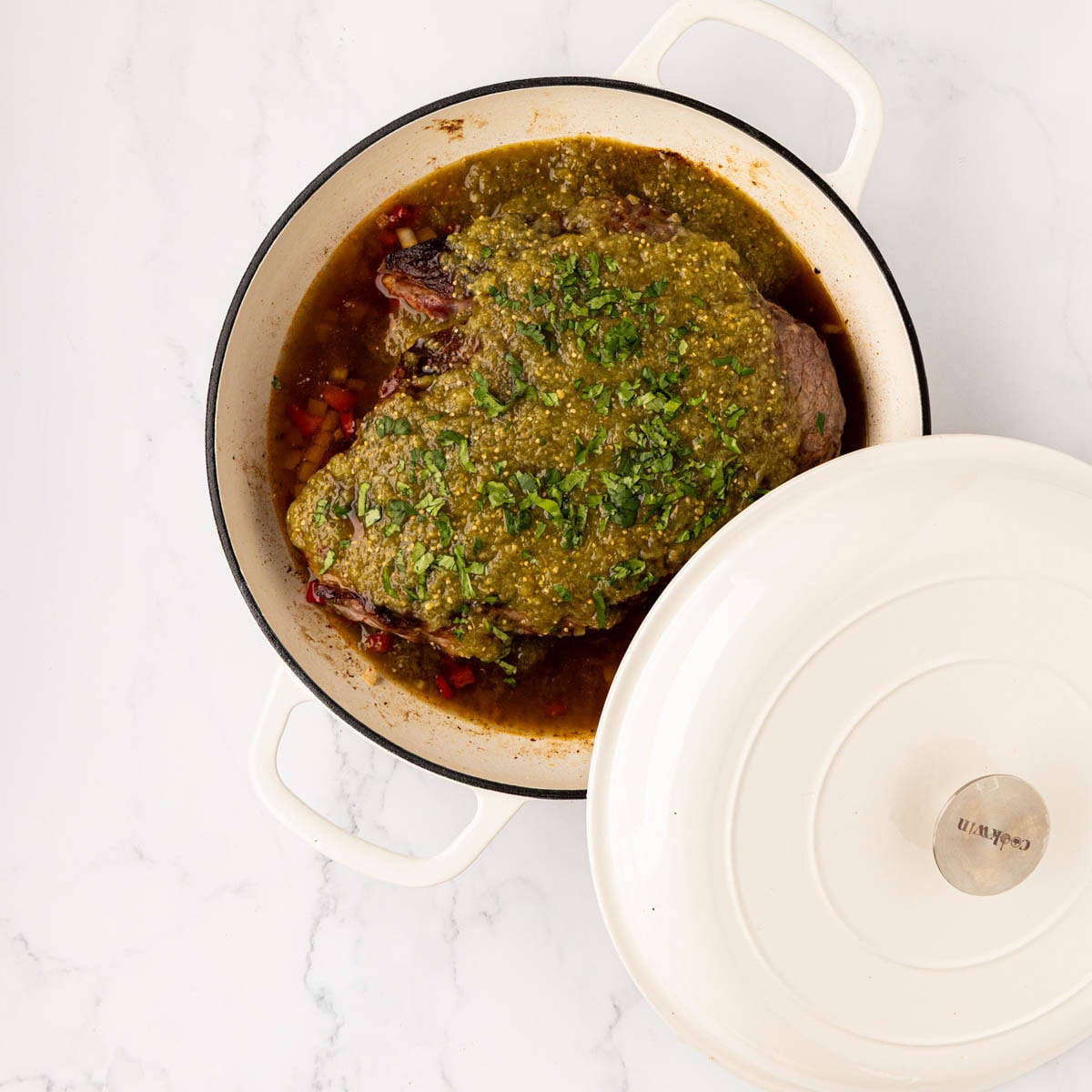 Lid going on top of the pot roast before braising in the oven.