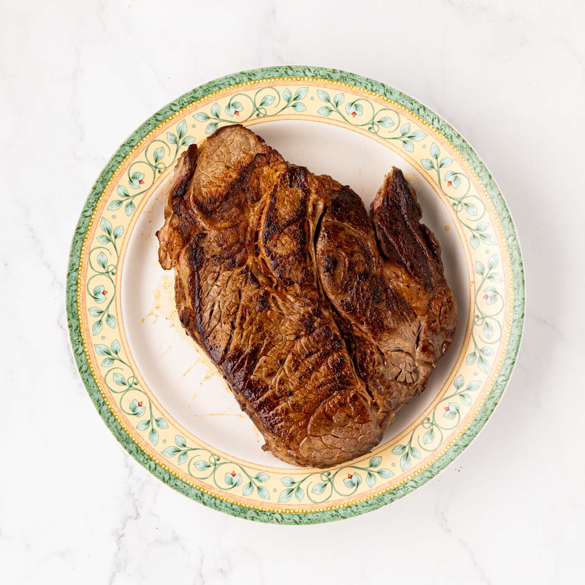 Seared pot roast placed on a plate.