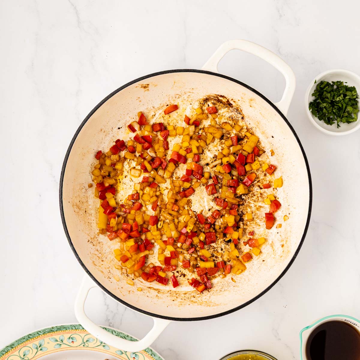 Softened saut&eacute;ed veggies in a skillet.