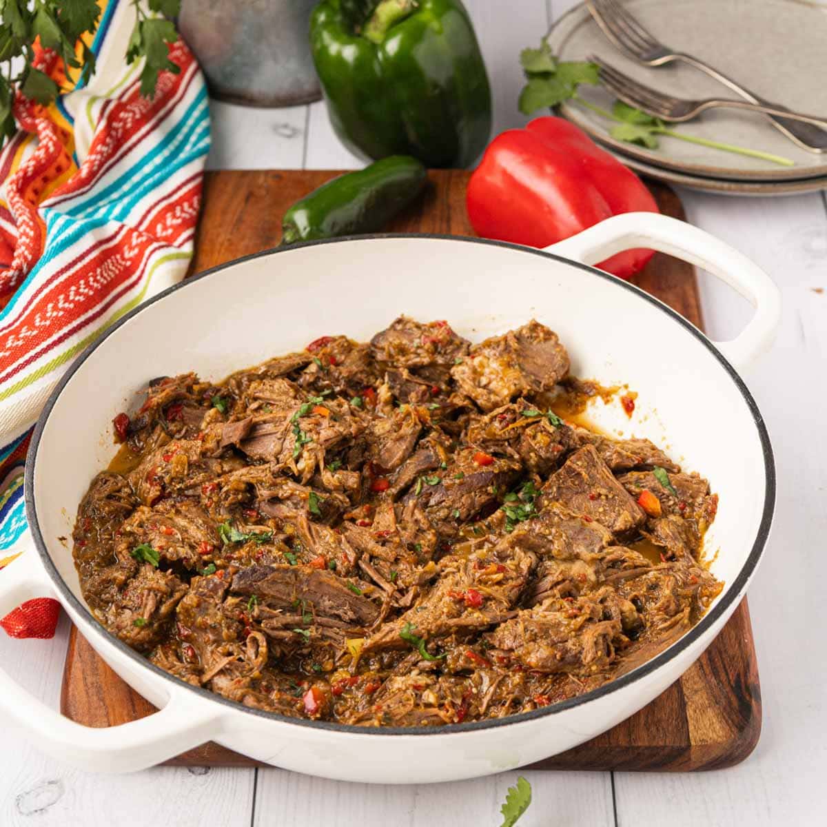 Finished Mexican pot roast shredded and served in a dutch oven.