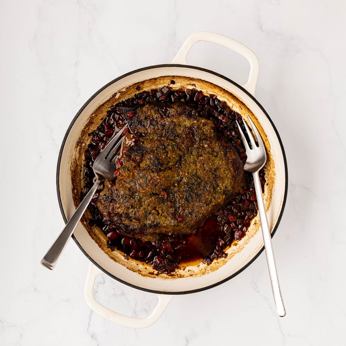 Finished Mexican pot roast in a Dutch oven before shredding the meat.