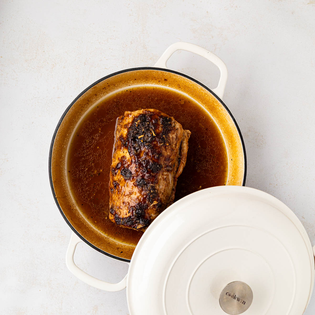 Finished roasted pork roast in the dutch oven with the lid off.