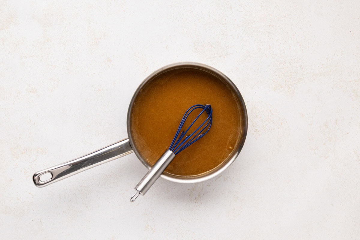 Broth added to the pork gravy in a saucepan.
