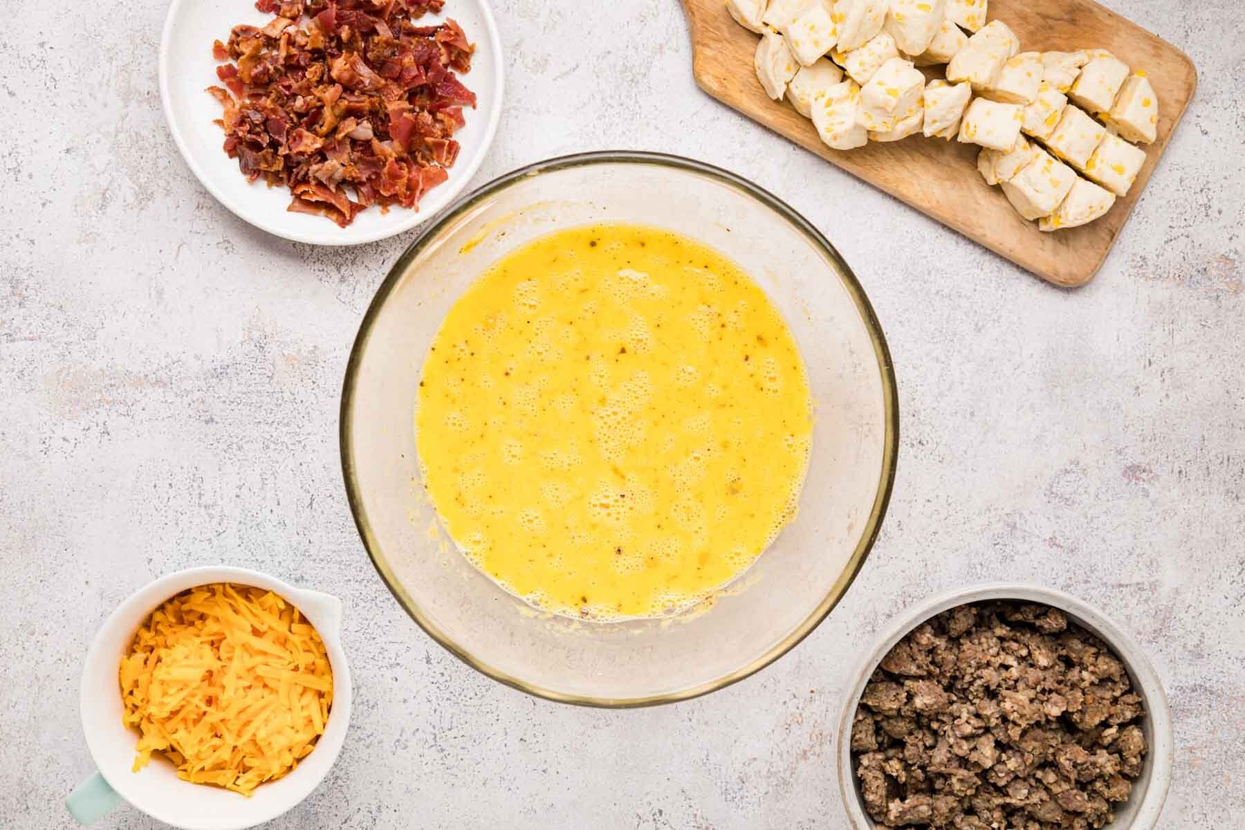 Eggs, milk and spices whisked together in a large bowl.