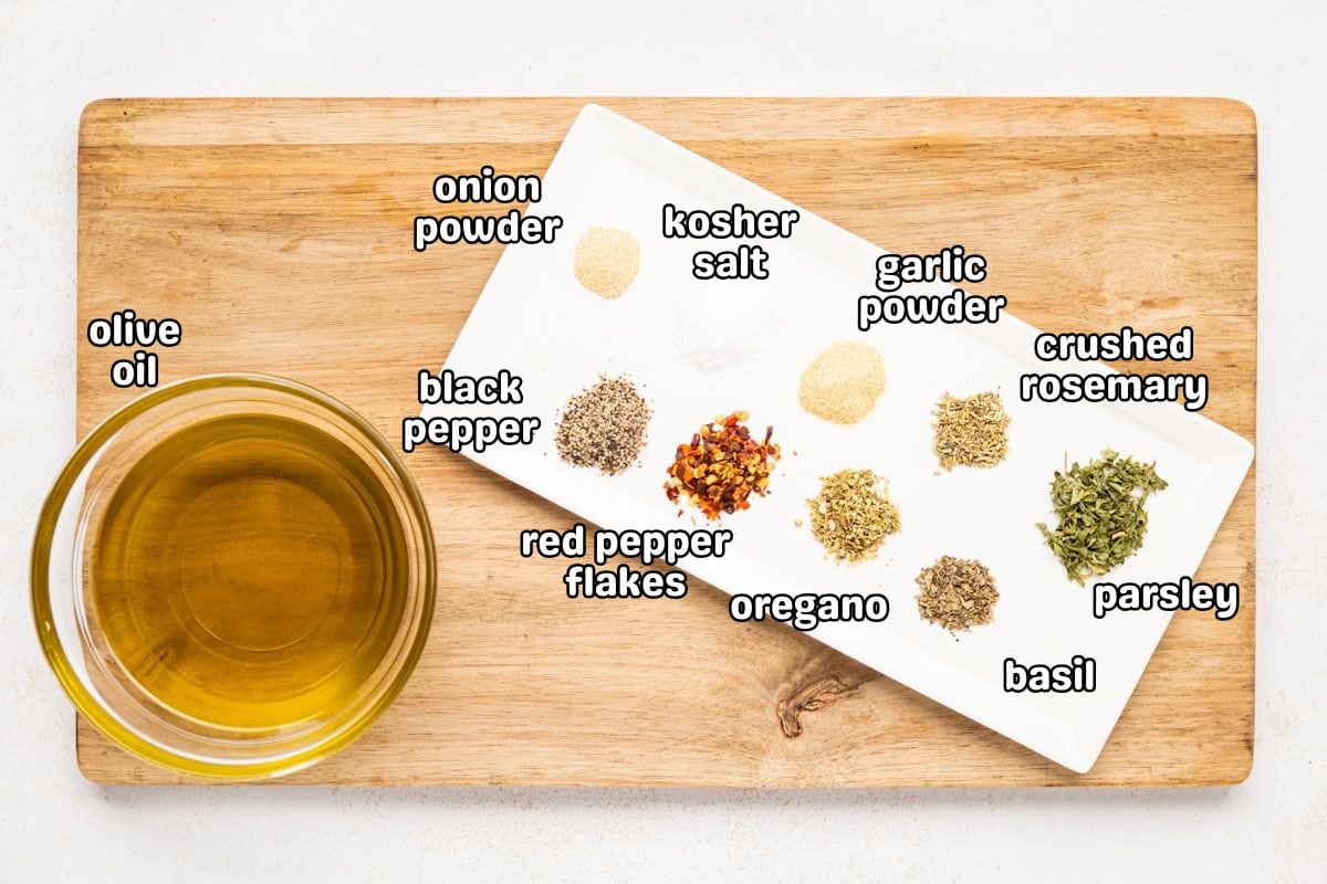A labeled image with a bowl of olive oil and the herbs needed to make the Italian herb blend for Carrabba's bread dipping oil.