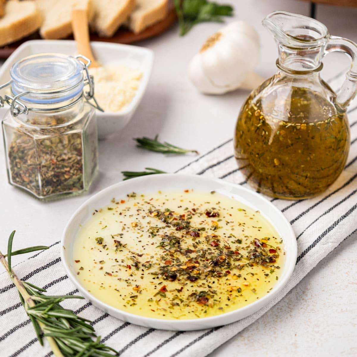 white appetizer plate with Italian herbs mixed with olive oil for a bread dip.