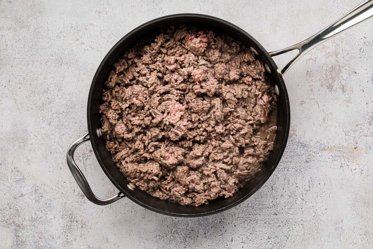 Ground beef being browned in a skillet.
