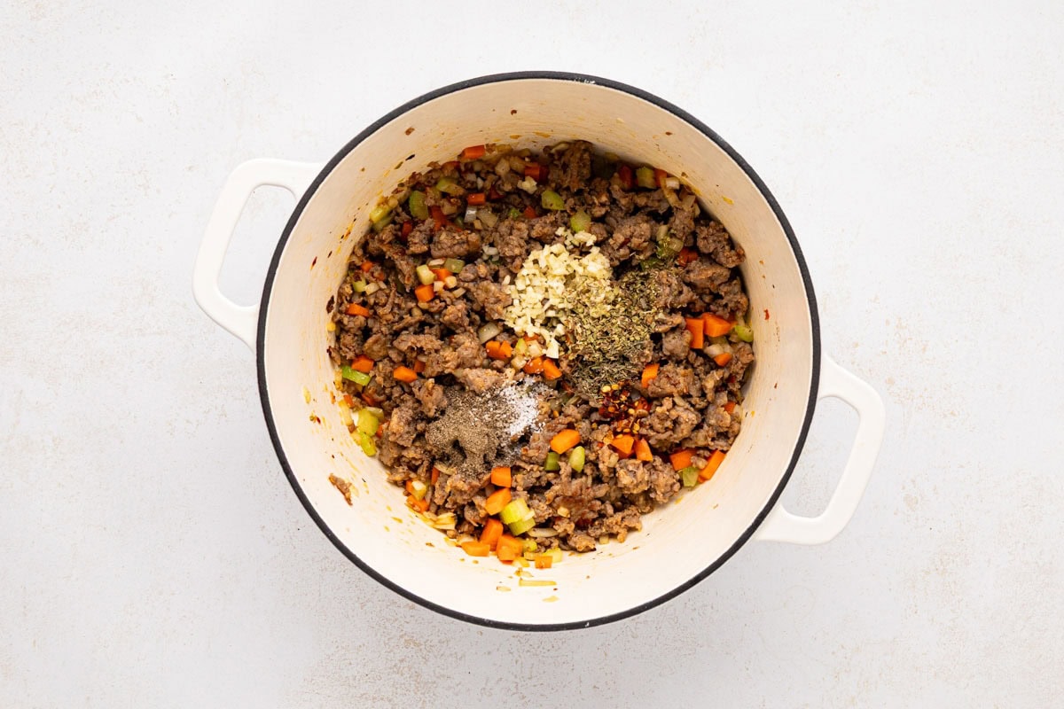 Seasonings added the cooked down aromatics and Italian sausage in the dutch oven. 