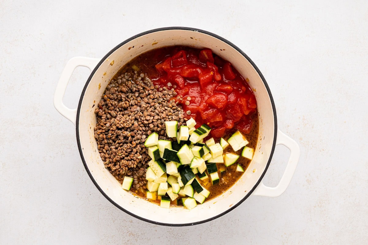 Diced tomatoes and zucchini added to the pot.