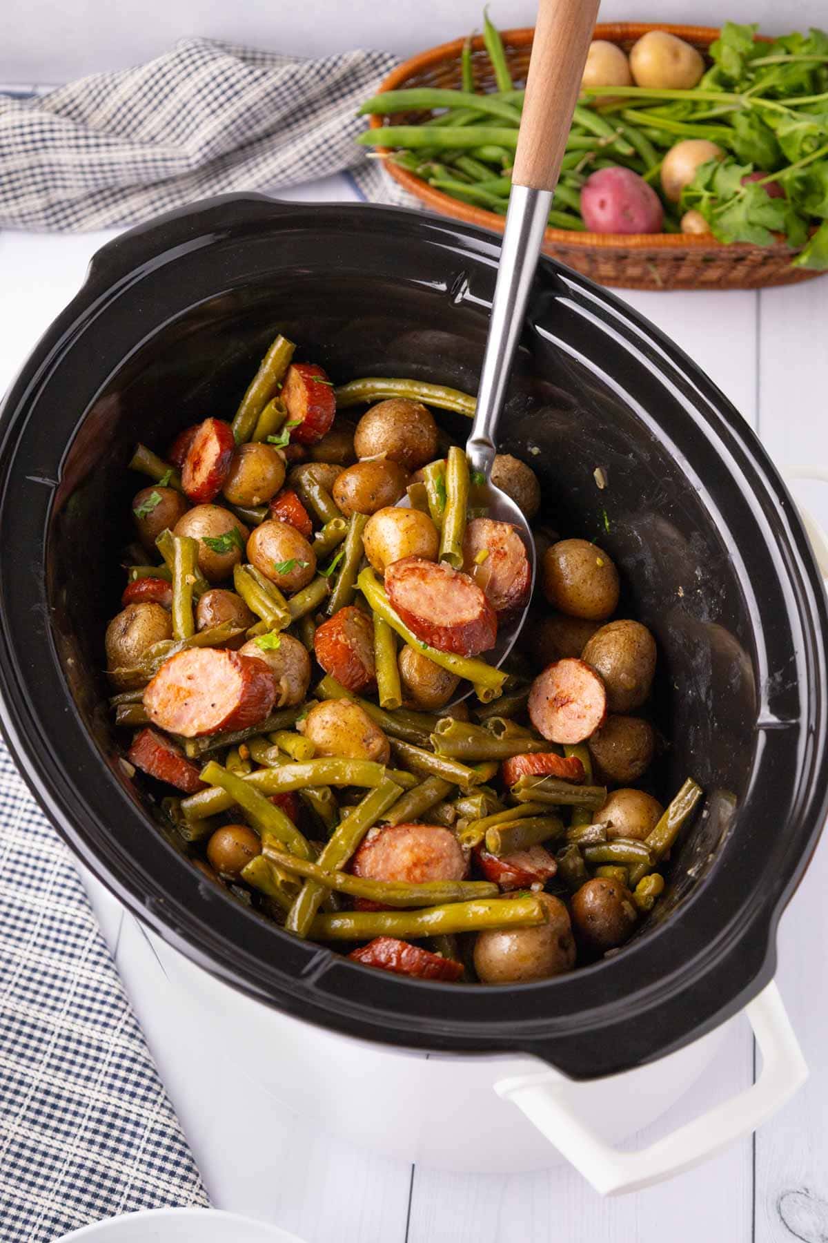 Serving spoon in the crockpot of finished swamp potatoes.
