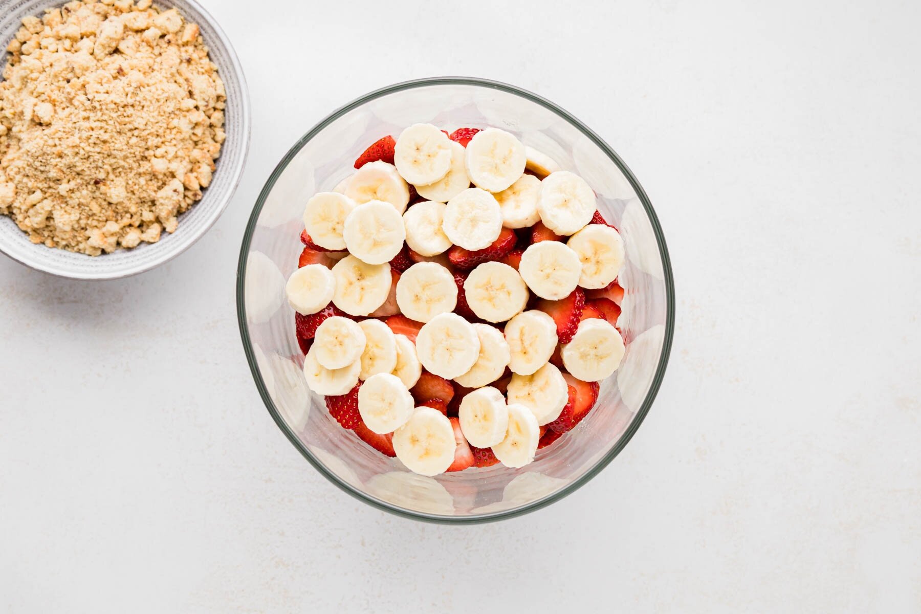 Layered sliced strawberries and sliced bananas on top of pudding layer.