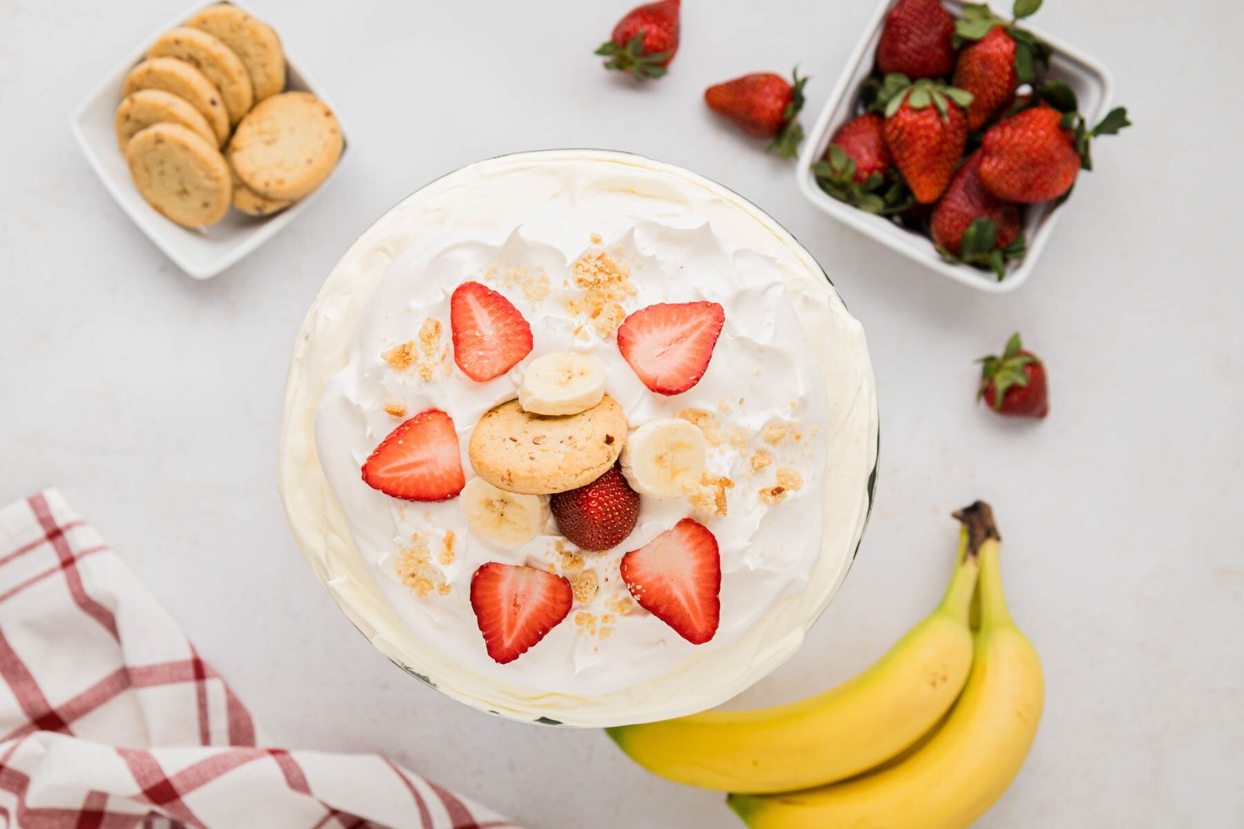 An overhead view of the strawberry banana pudding with sliced berries bananas and cookies on top.