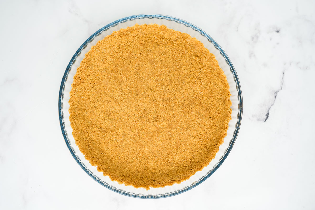 Graham cracker crust pressed into a pie dish.