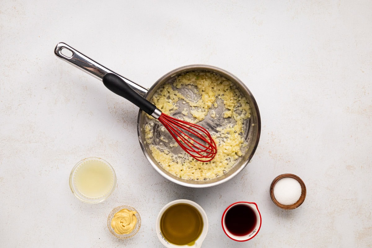 Flour whisked into onion and garlic to make a rue.