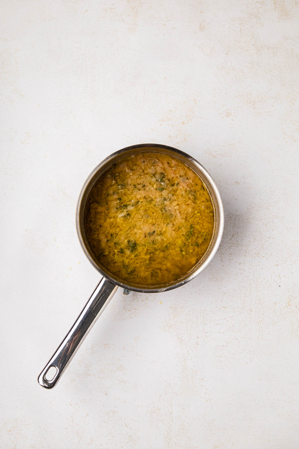 Parsley added to oil and herb mixture to finish baste.
