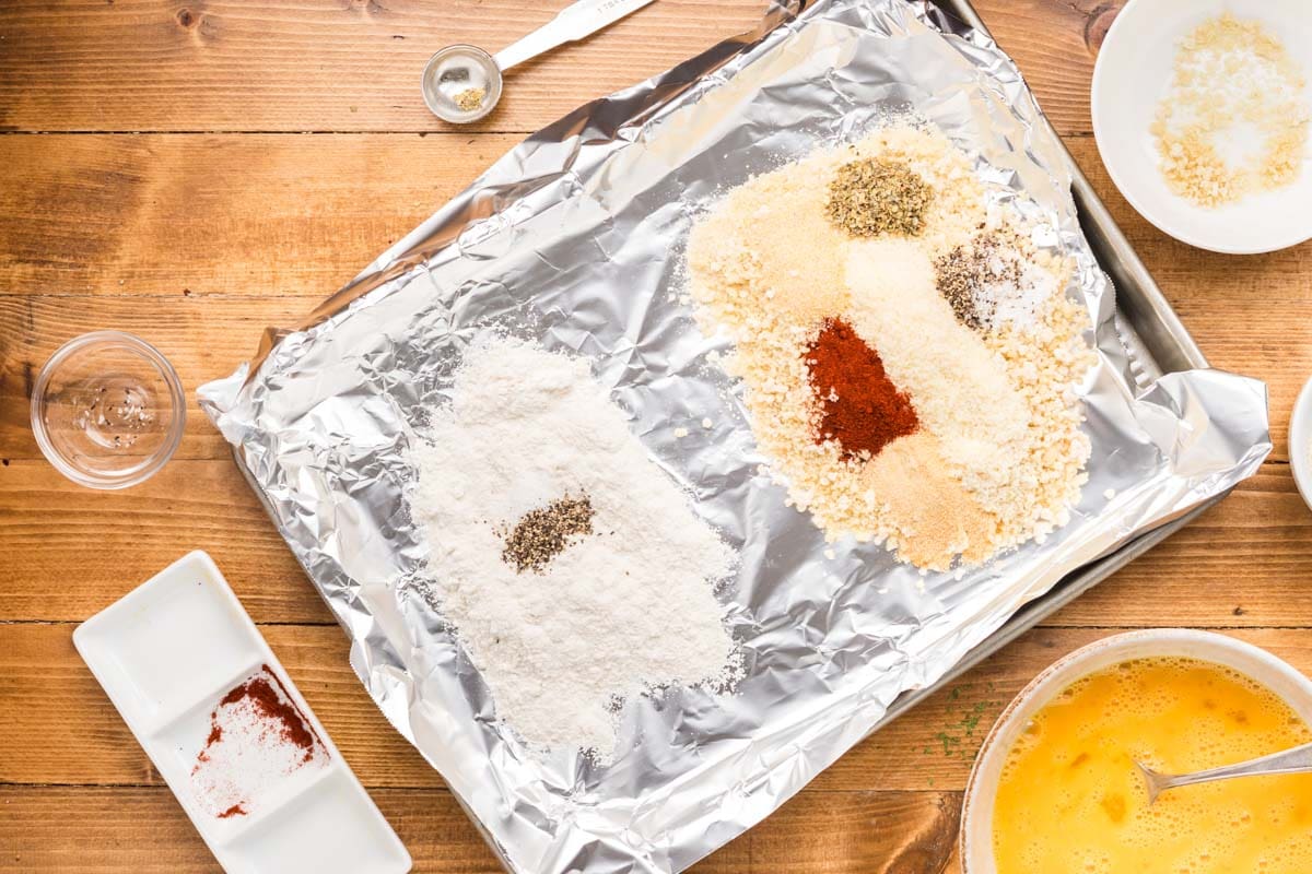 Flour dredging mixture and panko breading mixture both on a sheet pan.