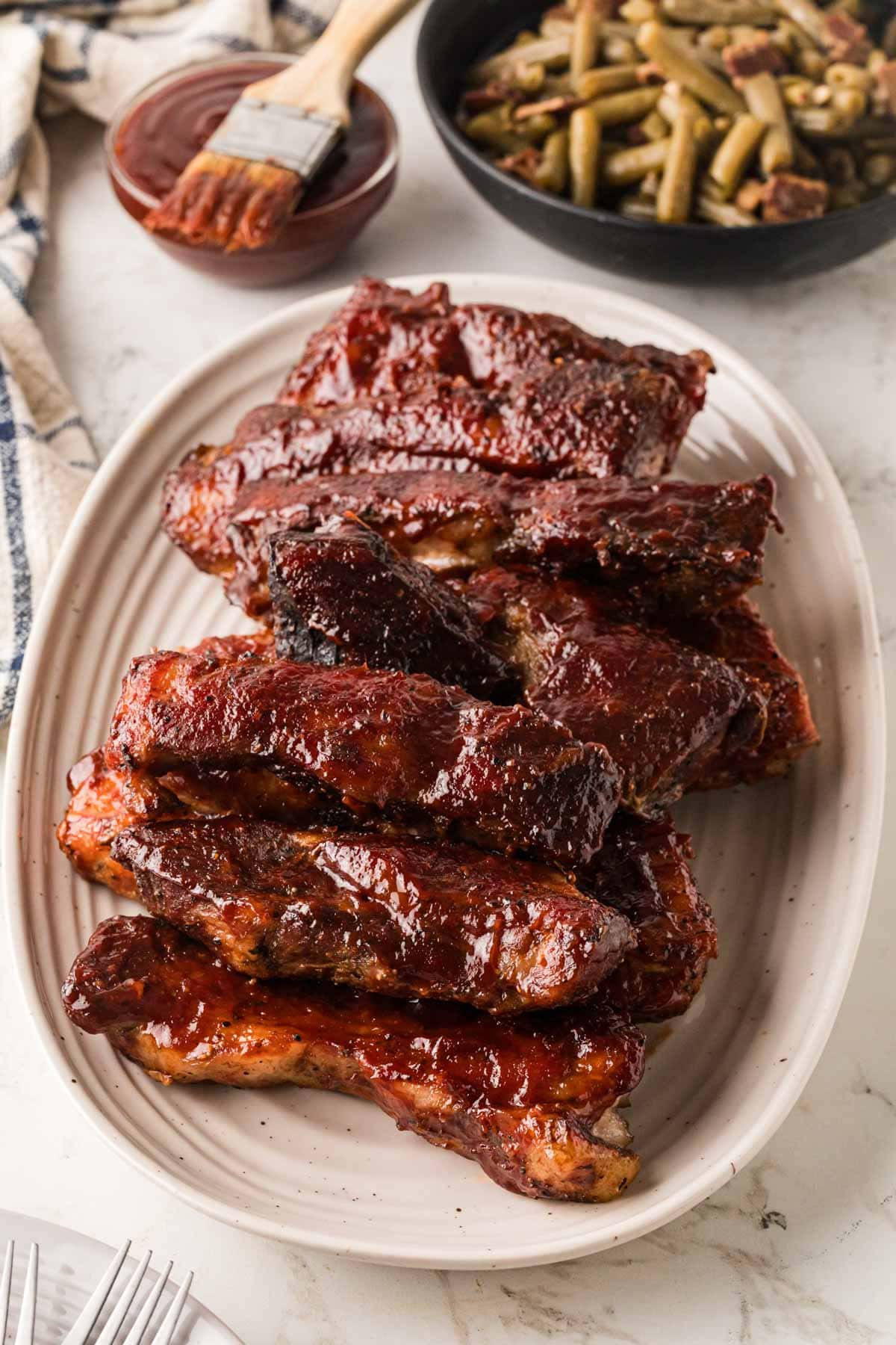 BBQ Country style pork ribs on an oval platter.