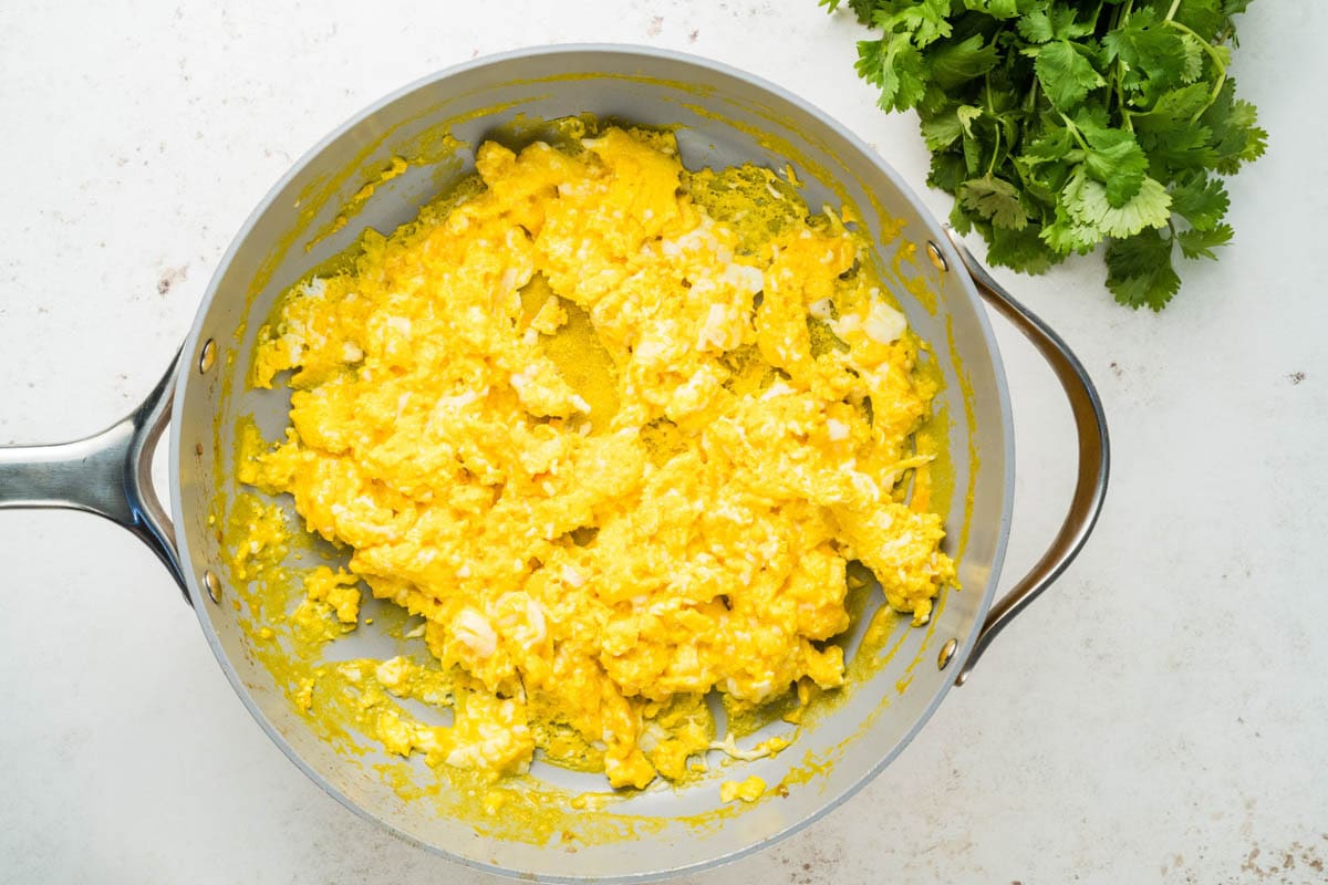 Scrambled eggs in a skillet.