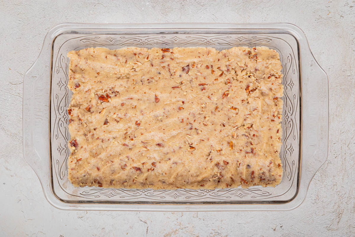 Flour, butter and nut mixture pressed into the bottom of a glass baking dish.