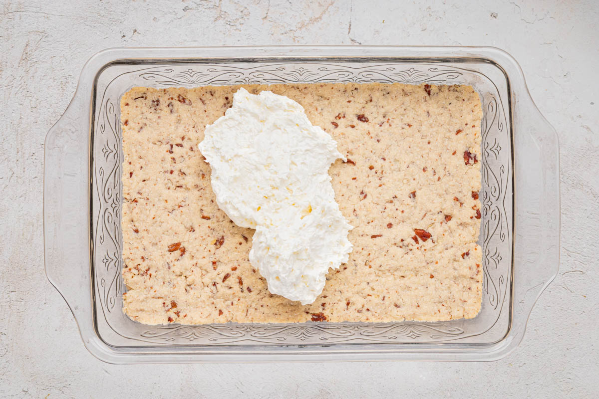 Cream cheese whipped mixture plopped on top of the crust.