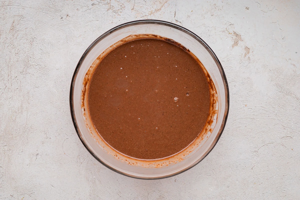 Chocolate pudding mixed with milk in a bowl.