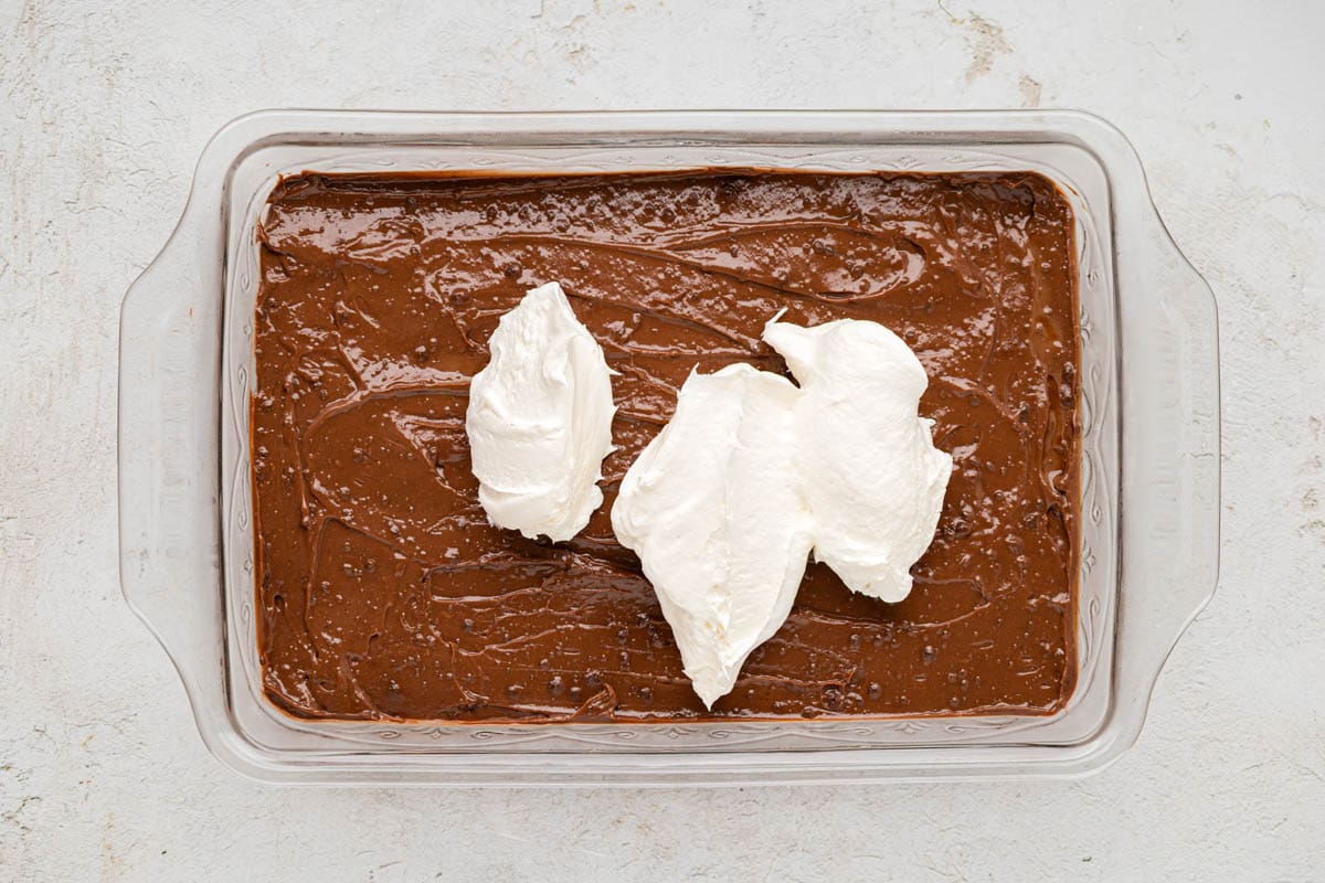 Whipped topping added on top of the chocolate pudding layer.