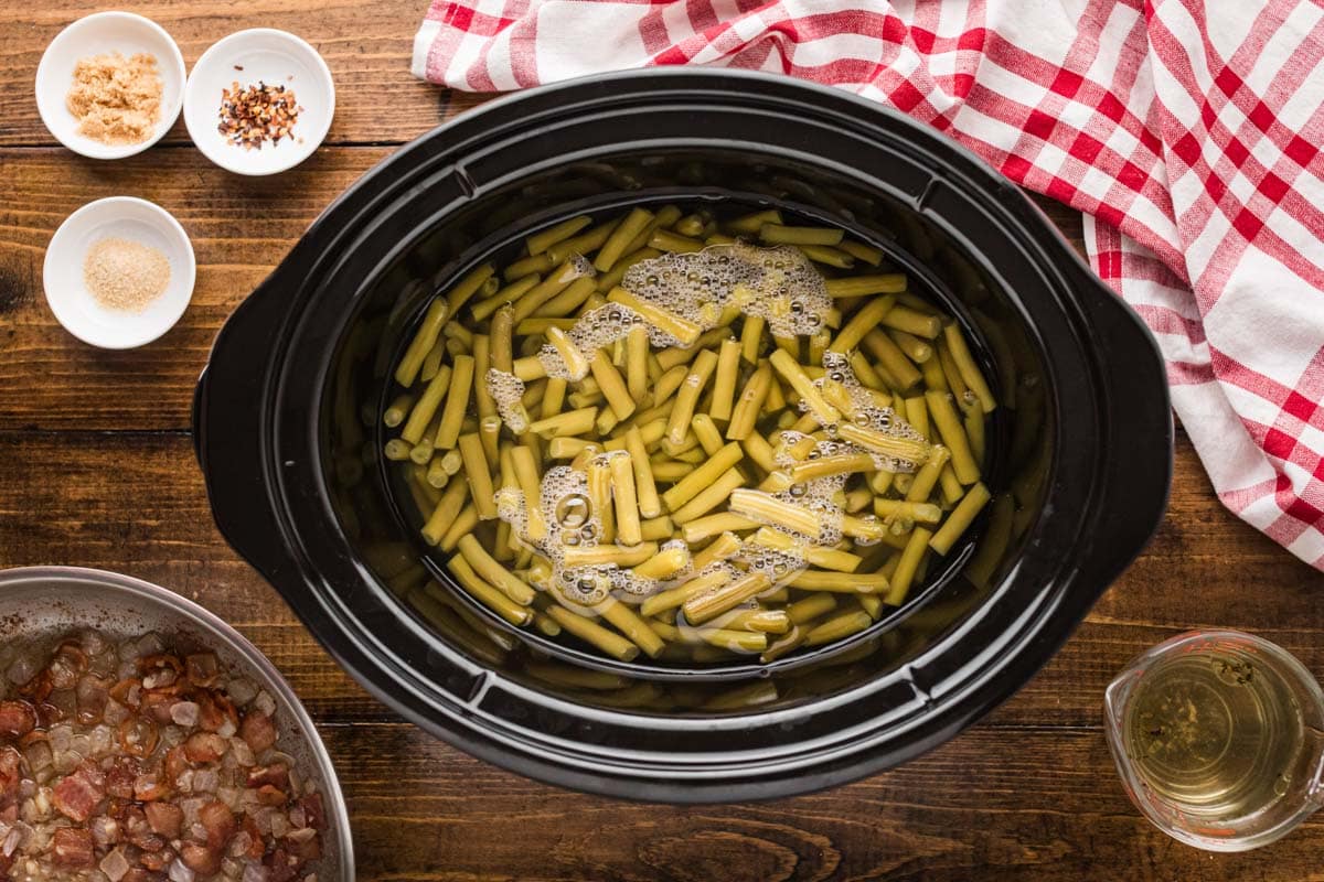 Canned green beans added to the slow cooker.