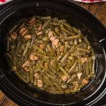 Cooked southern green beans in a crock pot.