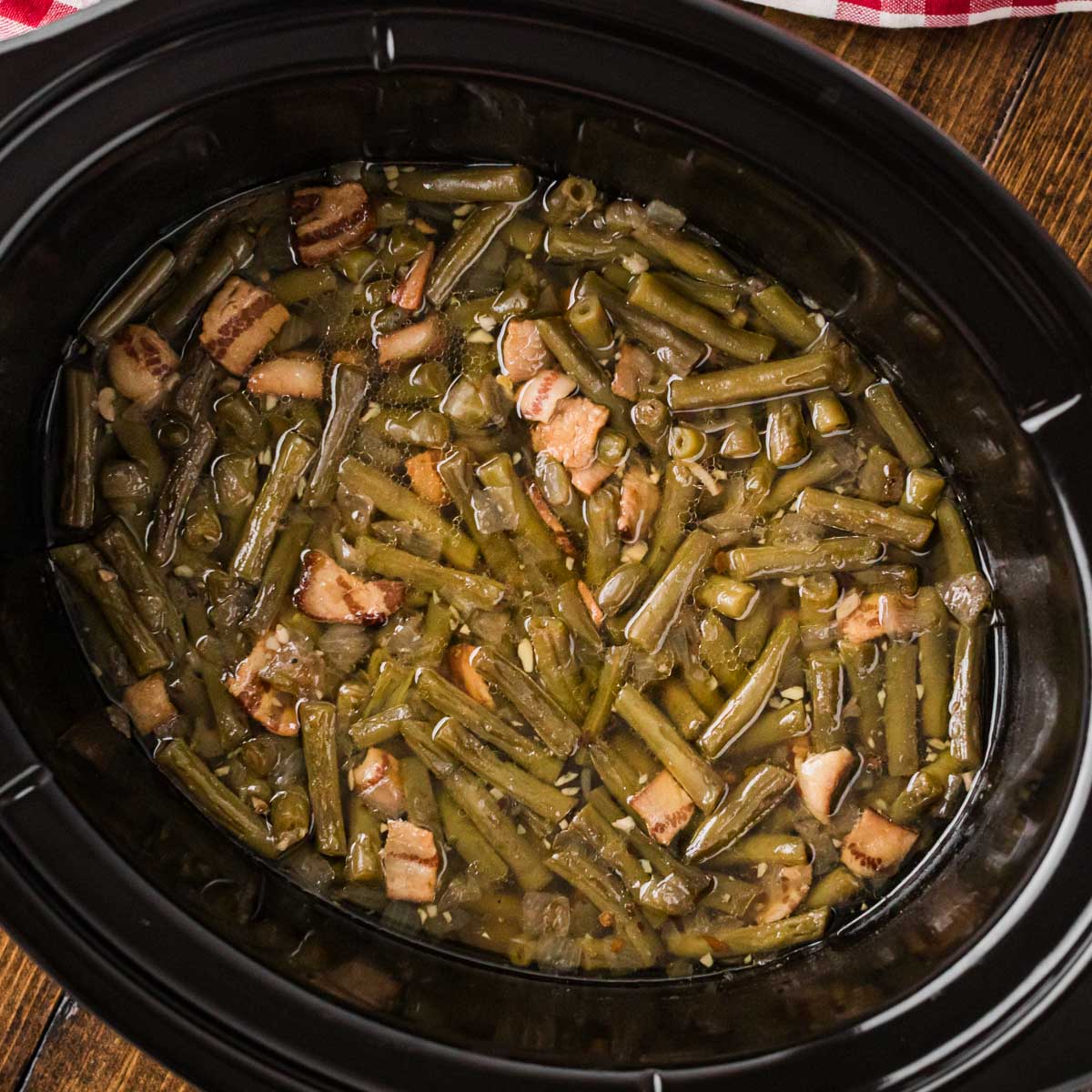 Cooked southern green beans in a crock pot.