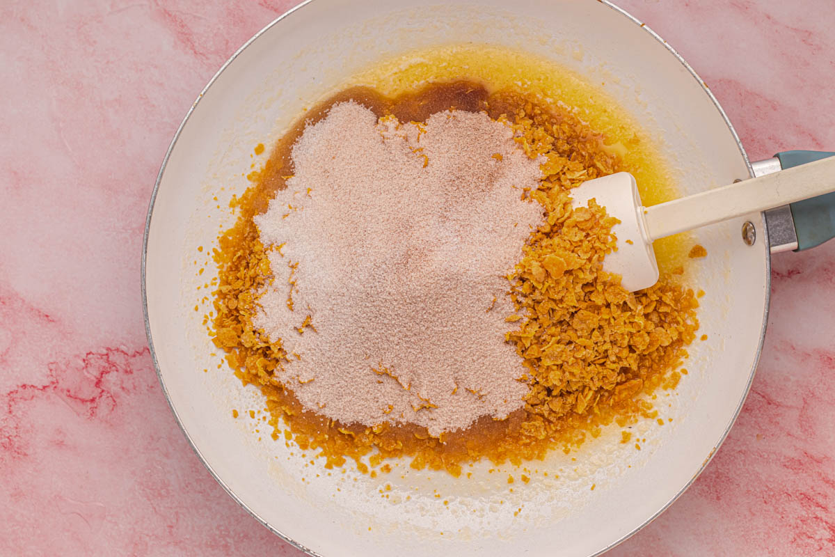 Melted butter, crushed cornflakes and cinnamon sugar in a skillet.