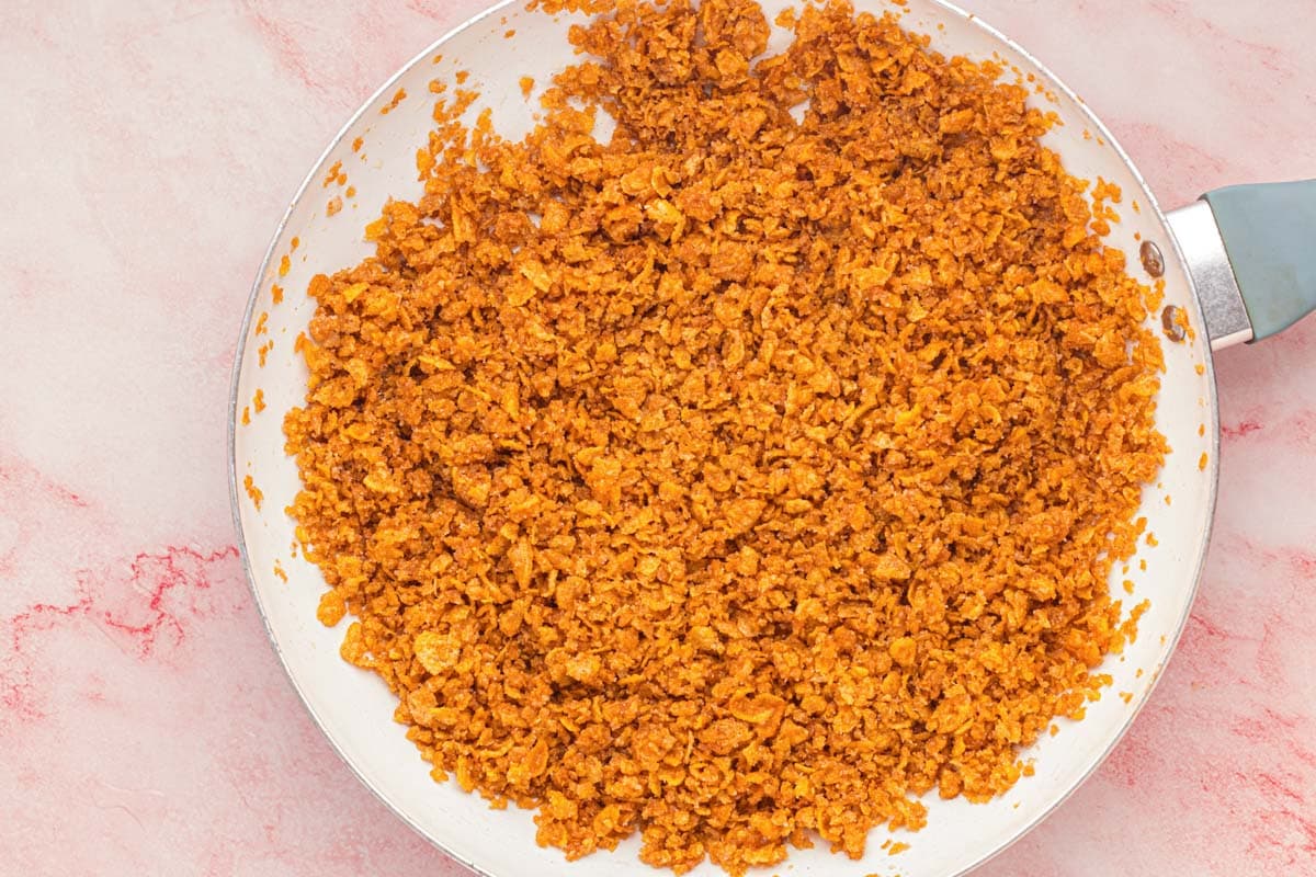 Toasted corn flake mixture in skillet.