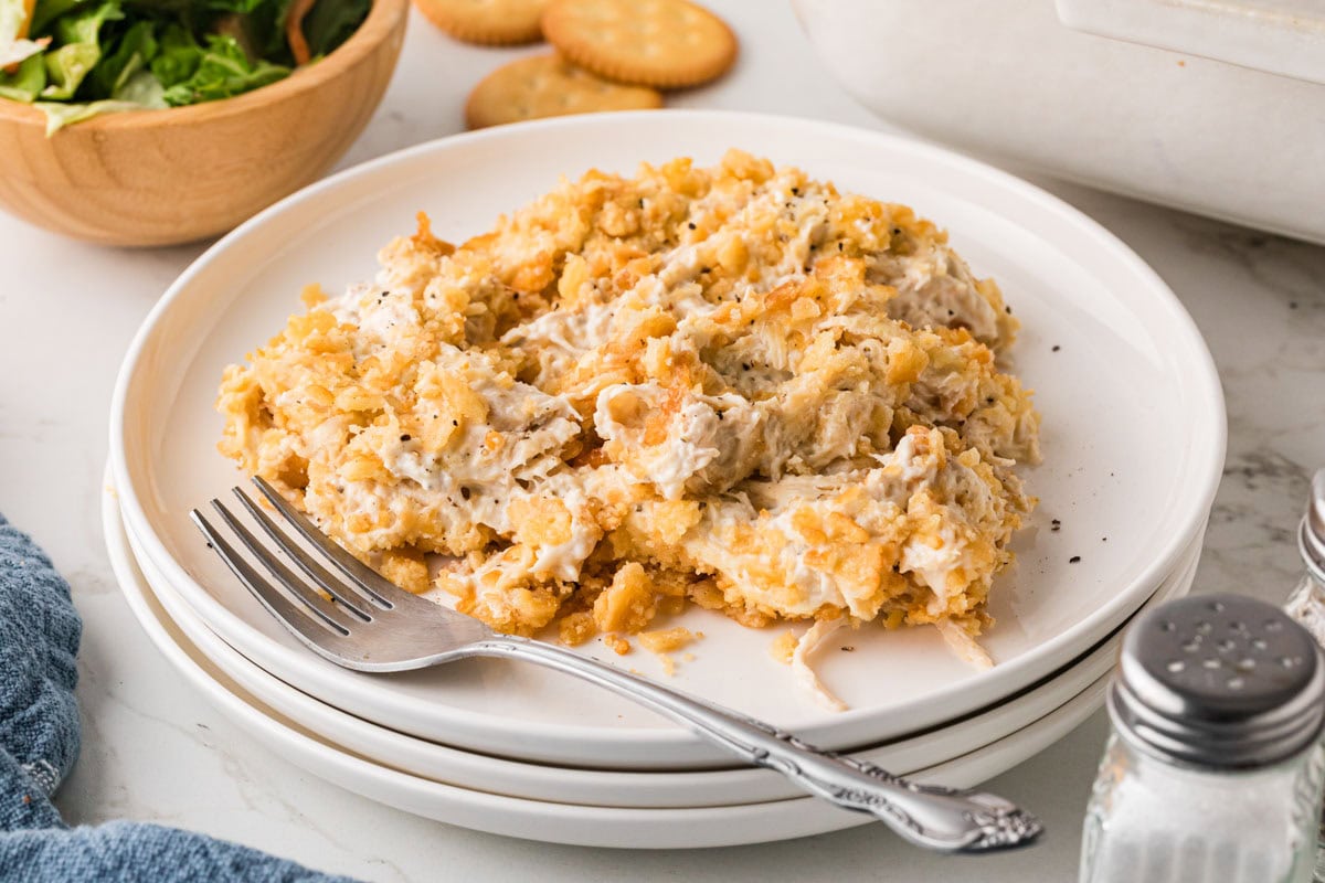 Ritz cracker chicken casserole served on a white plate with a fork.
