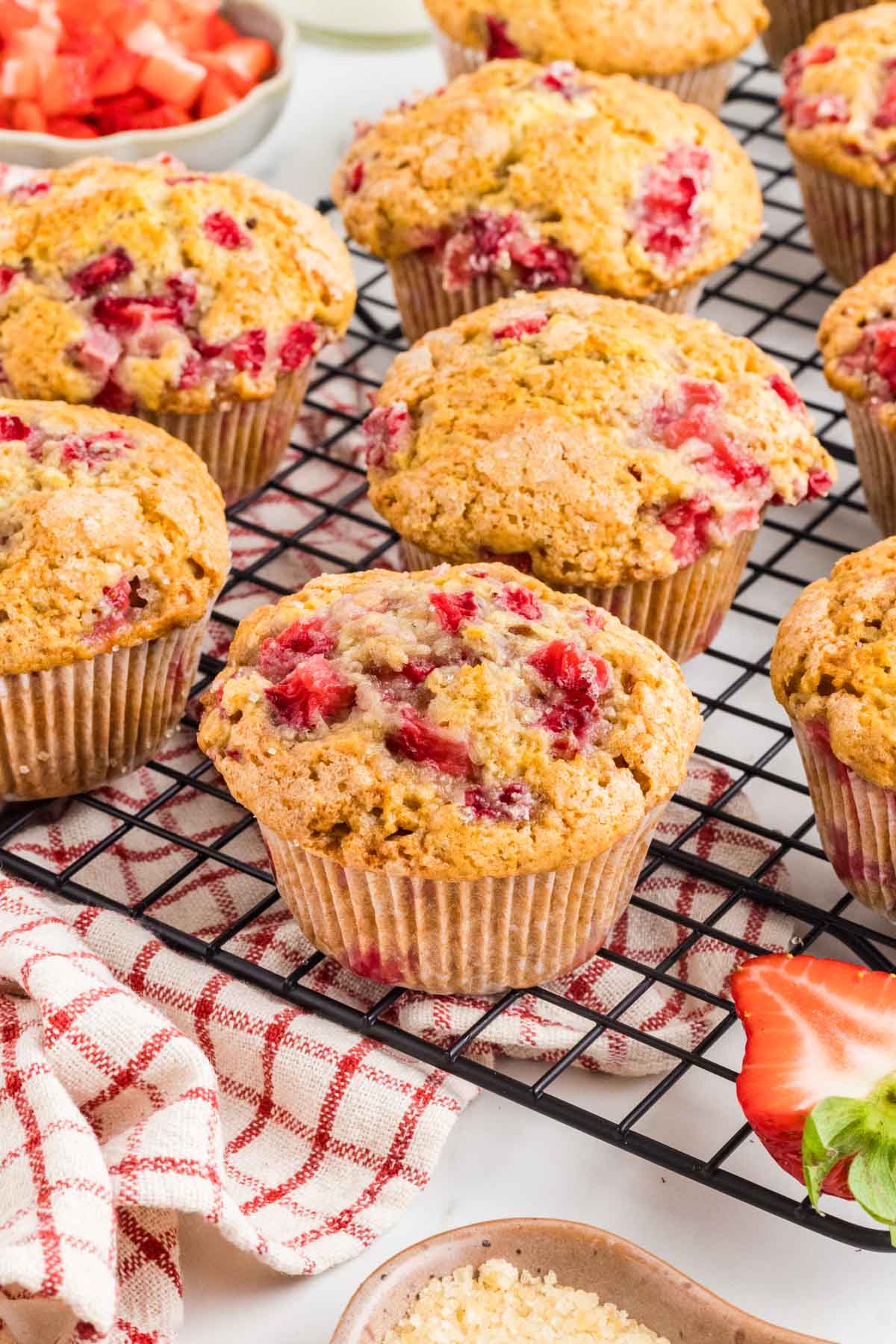 Bakery style strawberry muffins on a cooling wrack after baking.
