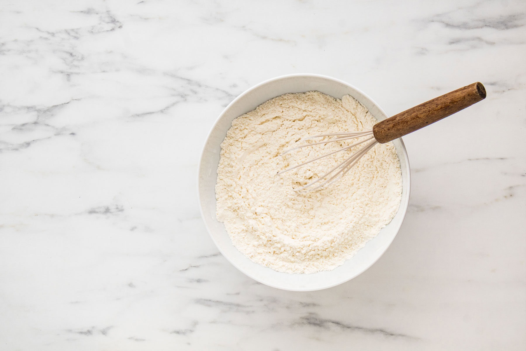 Whisking together the dry ingredients for strawberry muffins.