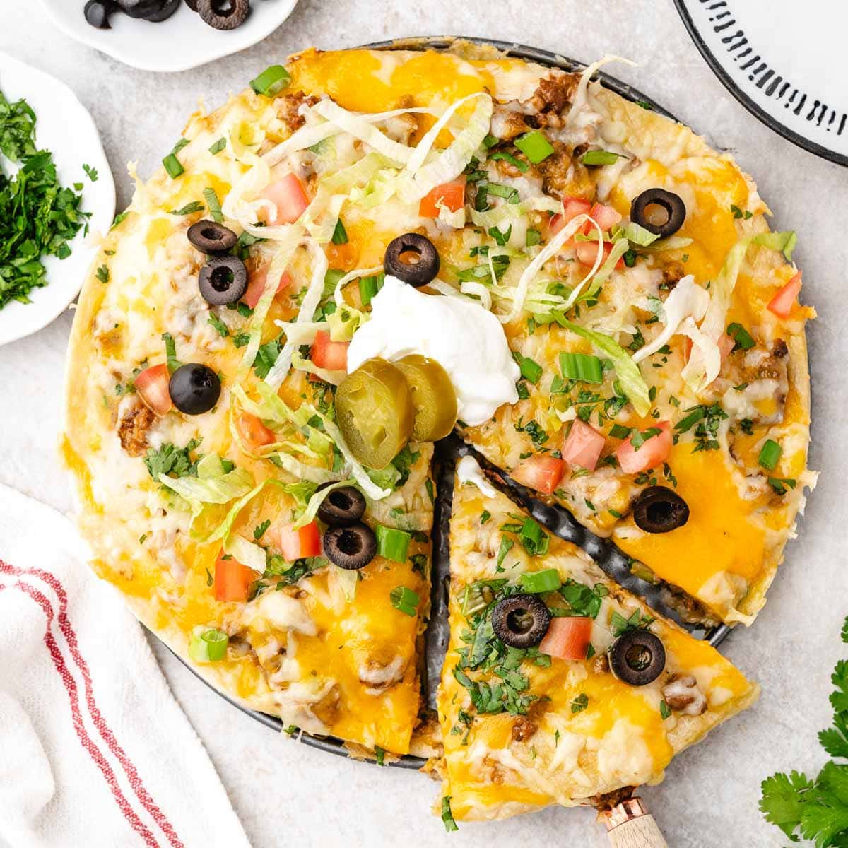 Overhead shot of a taco casserole with one slice being taken.