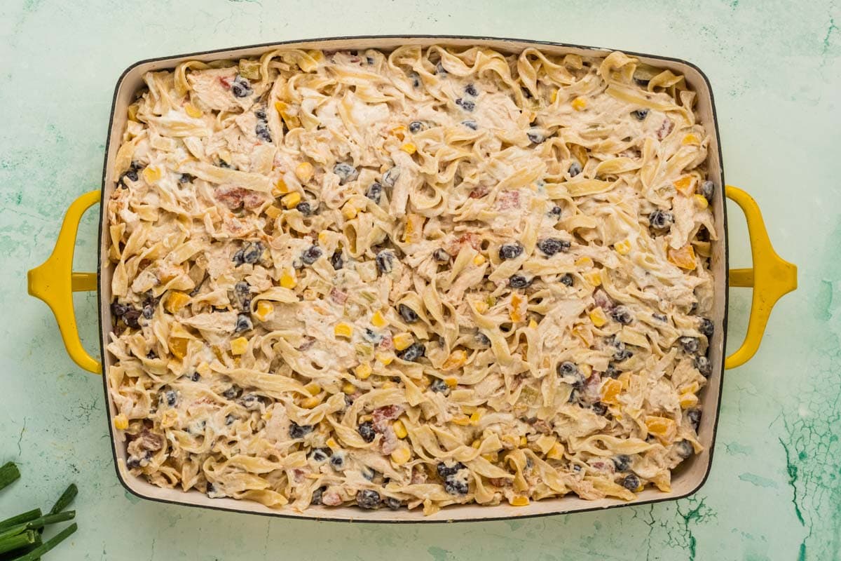 Tex Mex chicken noodle casserole mixture placed into a baking dish.