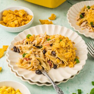 Serving of Tex Mex chicken noodle casserole on a plate with a fork.