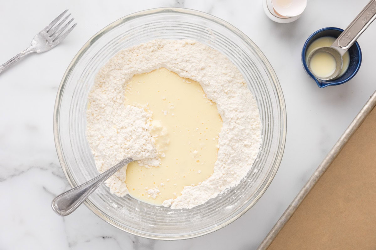 Buttermilk mixture added to the flour mixture in a bowl.