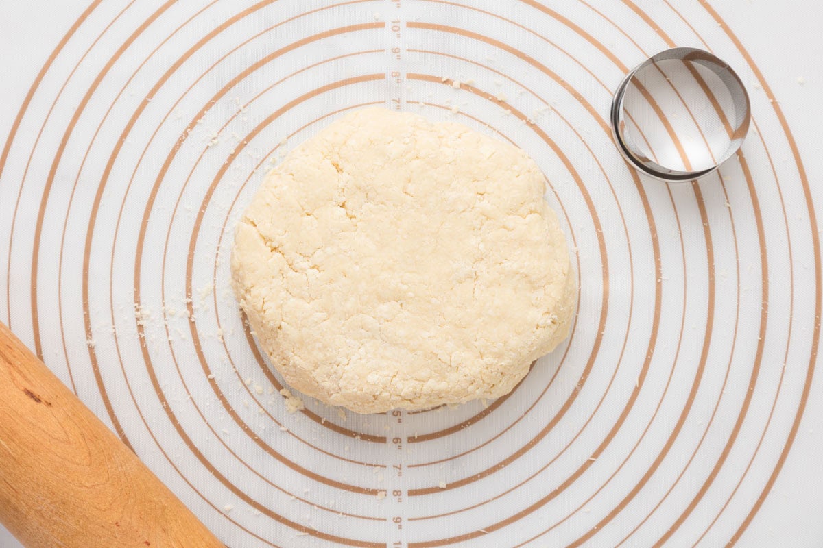 English scone dough shaped into a large disc.