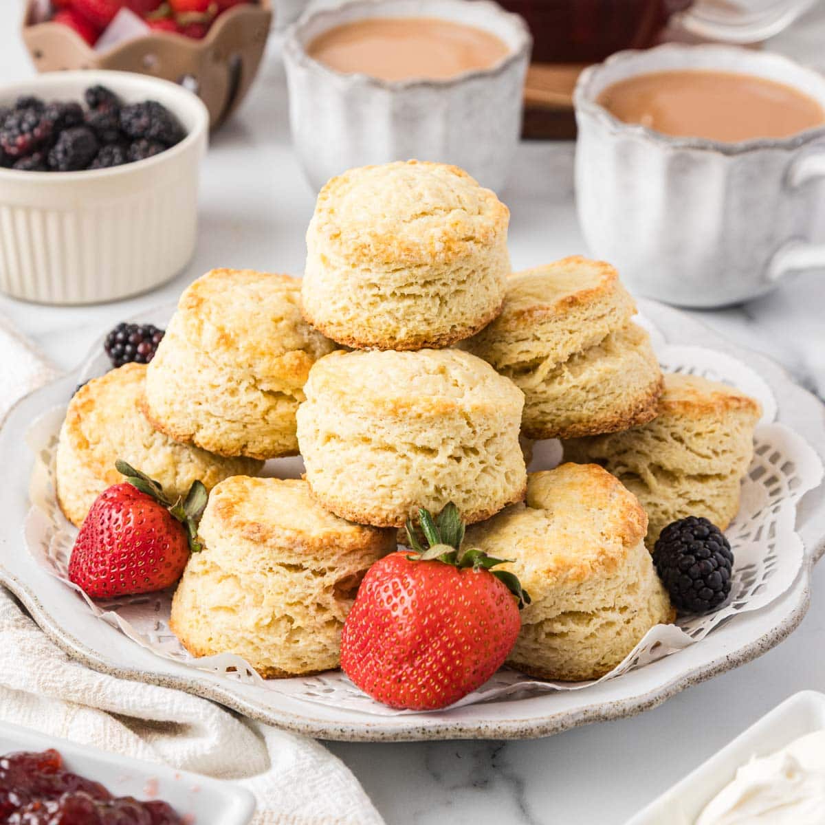 Side view of English scones stacked on top of each other served on a plate.