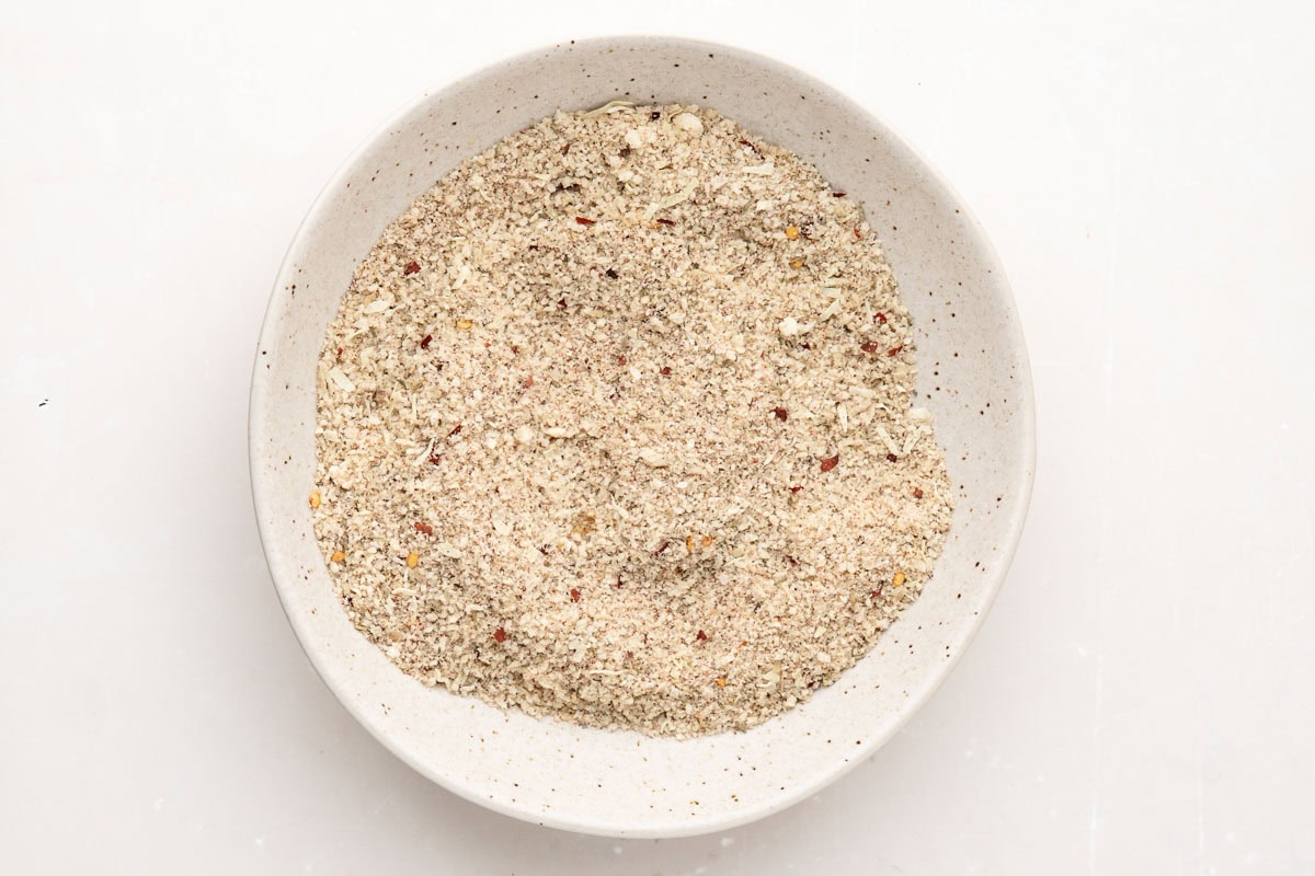Panko breadcrumbs, parmesan, and spices mixed together in a bowl.