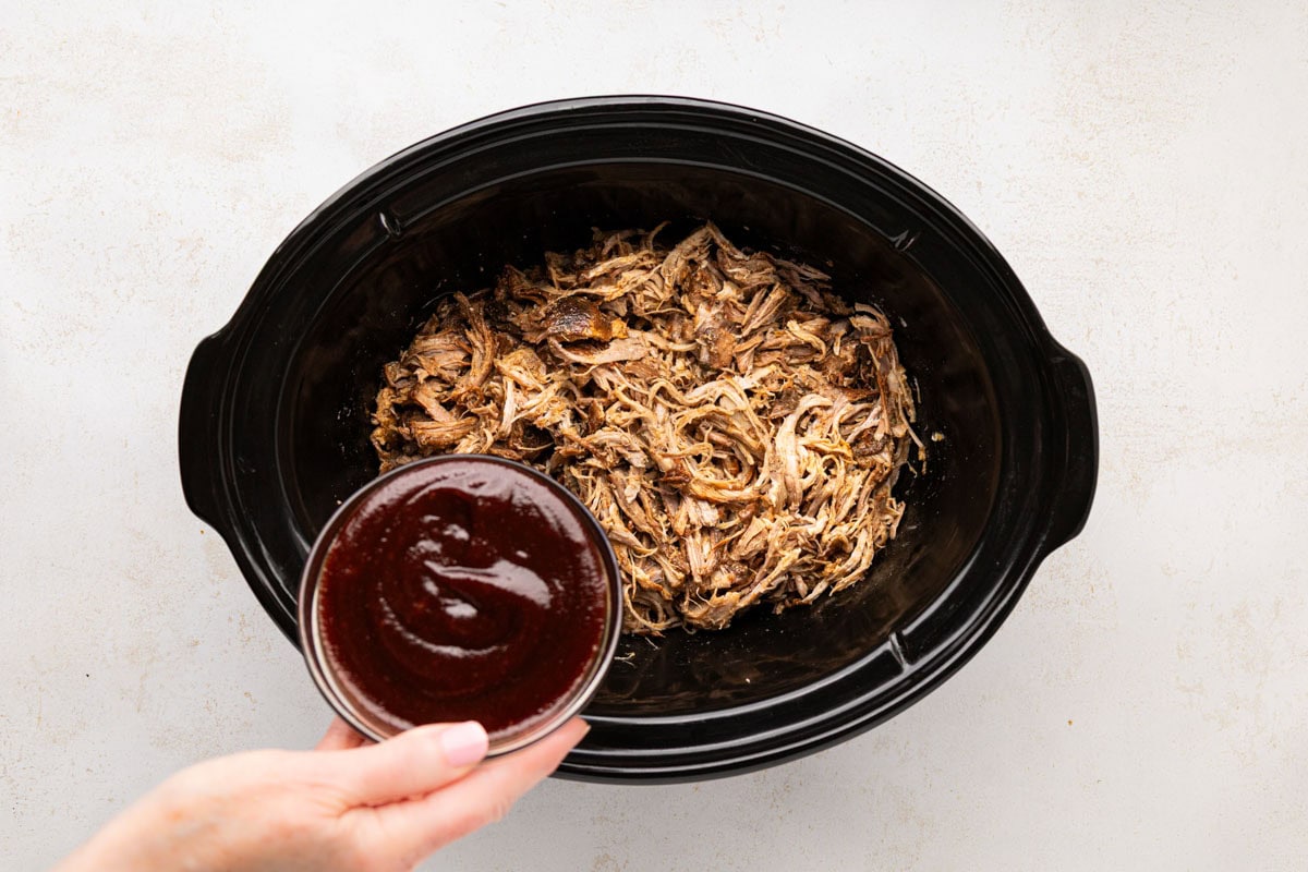 Pour in some of the bbq sauce over pulled root beer pork.