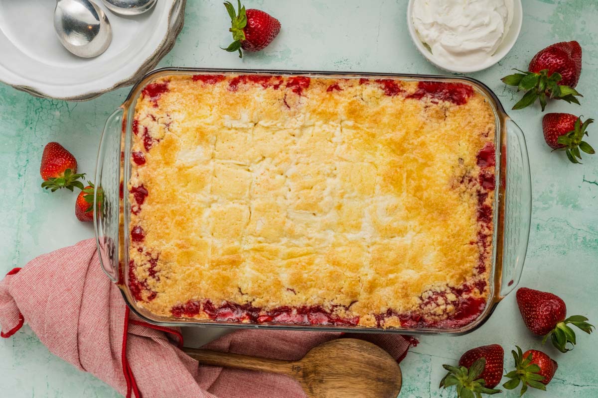 Finished strawberry dump cake in a glass baking dish after baking.