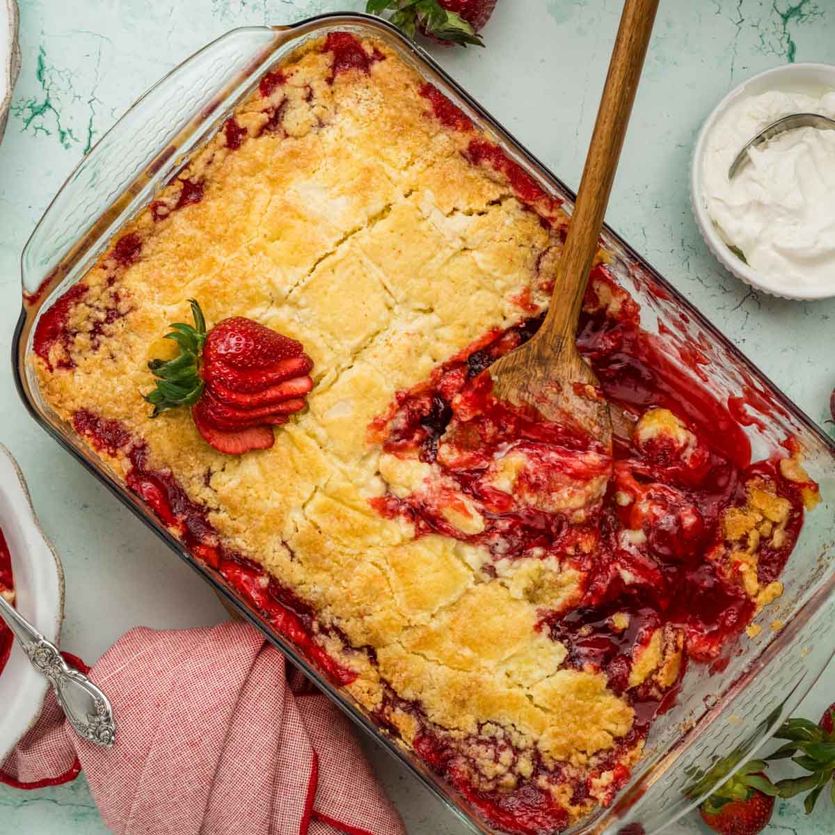 Overhead shot of strawberry dump cake in a glass baking dish.