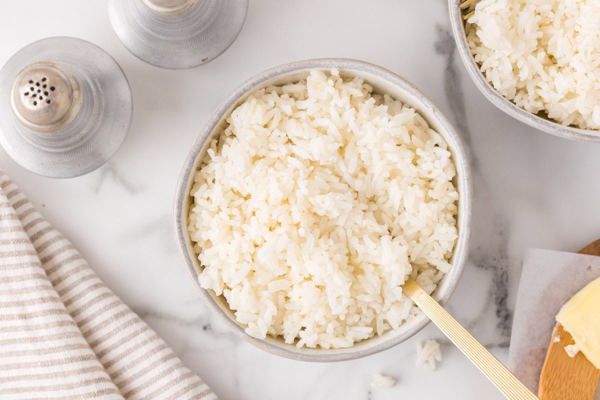 On overheat image of fluffy instant pot rice i a bowl with a gold fork.