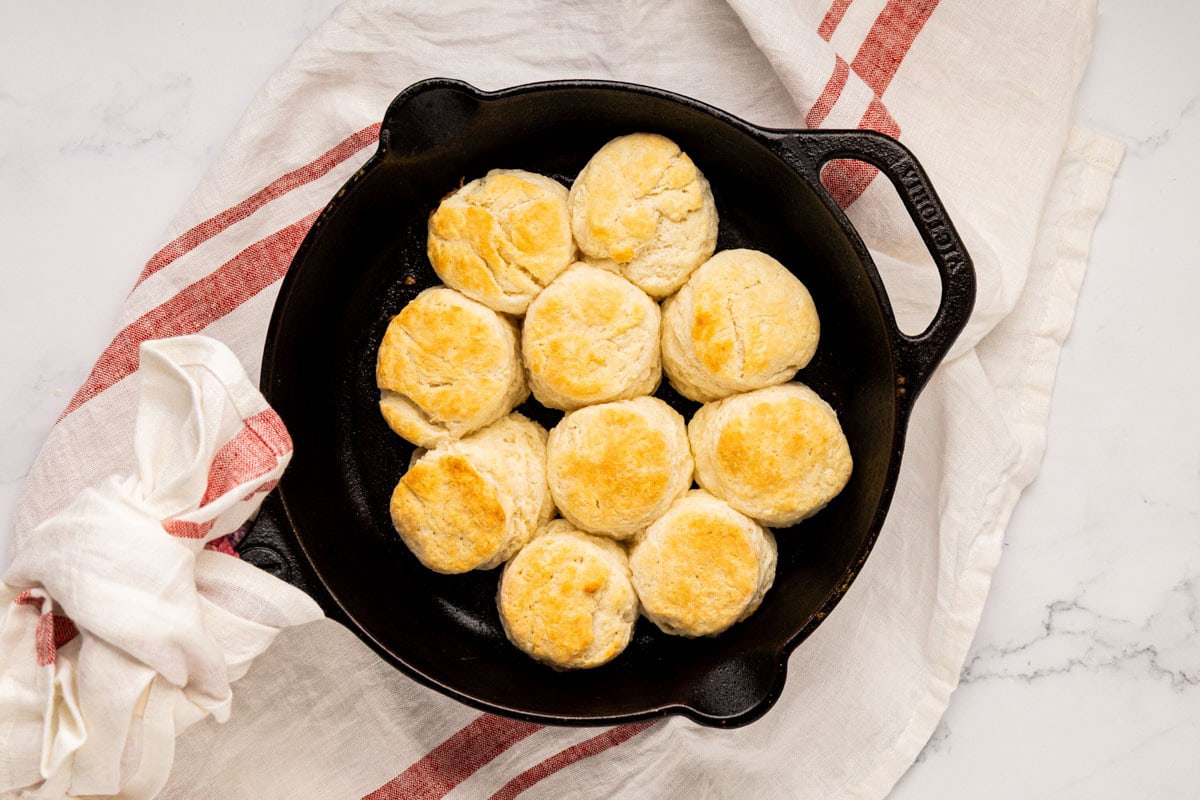 Baked biscuits in a cast iron skillet.