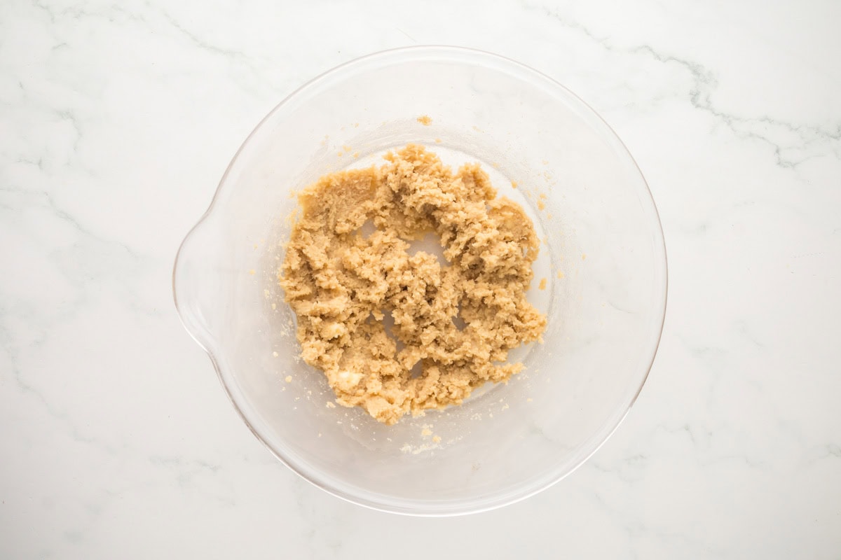 Sugars and butter creamed together in a mixing bowl.